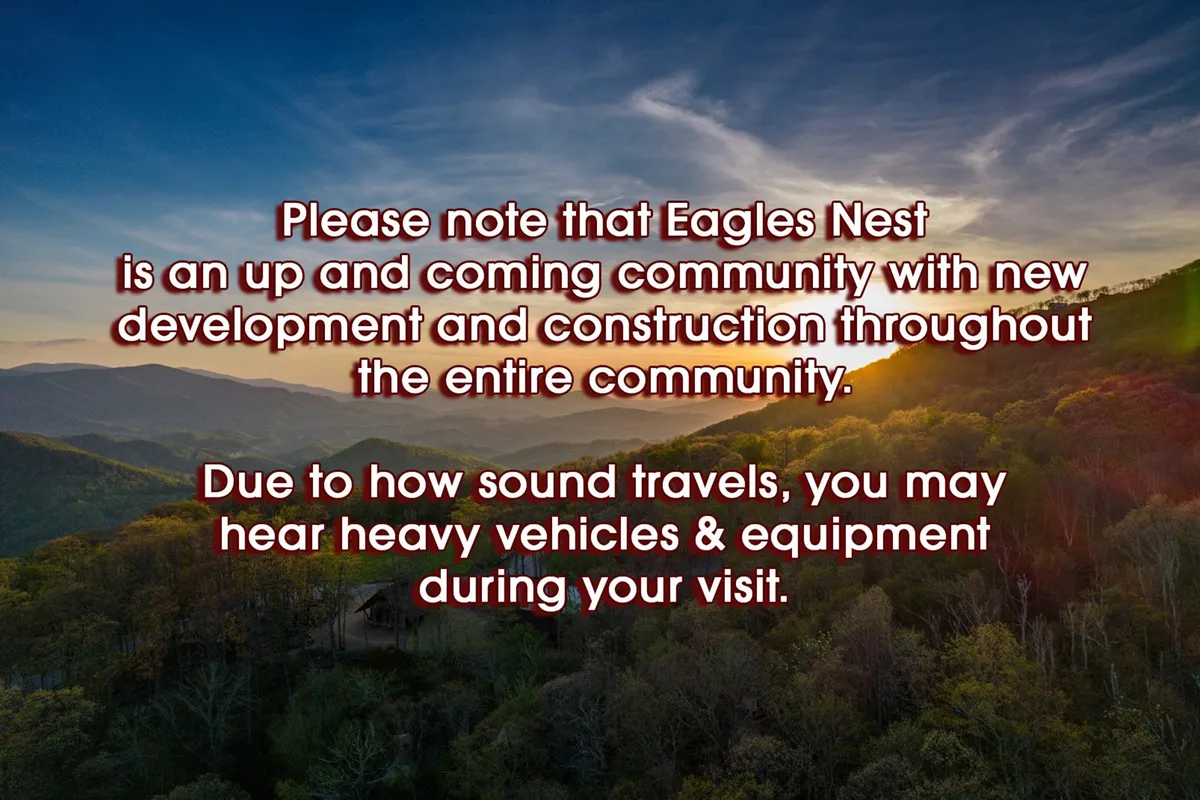 A wide view of the mountain landscape at sunset, with gentle construction signs visible amid hills and nature trails. The scene evokes the sense of a growing, evolving community, with natural beauty and ongoing progress side by side.